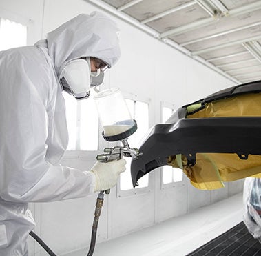 Collision Center Technician Painting a Vehicle | Oakes Toyota in Greenville MS
